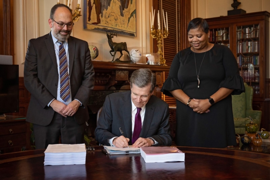 Gov. Roy Cooper signs the 2021-2022 budget, his first since taking office.
