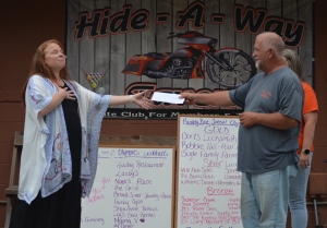 Stephanie Upton accepts $10,000 for the Richmond County Special Olympics from Hide-A-Way Tavern owner Chris Sachs on May 12. See the RO&#039;s Facebook page for photos from the May 7 ride.