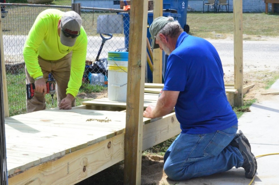 Enviva&#039;s Christopher Brown, left, and Jim Parsons, of Habitat for Humanity of the N.C. Sandhills, work on a wheelchair ramp Tuesday in Dobbins Heights.