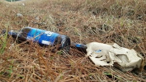 Two beer bottles are among the many scattered alongside Mizpah Road, highlighting the county&#039;s littering problem.