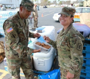 Soldiers enjoy baked goods sent by three local teens during Hurrican Irma disaster relief efforts.