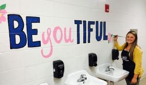 Rockingham Middle School&#039;s visual arts teacher Ashley Lupfer reminds students they are &quot;be-you-tiful&quot; by painting a mural in a student bathroom.