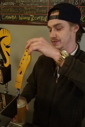 A bartender at The Bruin Craft Beer and Wine in New Bern pours a glass of White Zombie, a white ale made by Charlotte-based Catawba Brewing Company.