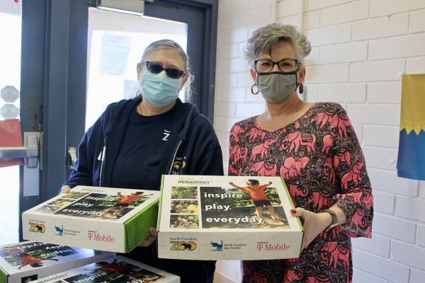 Linda Kinney, Education Specialist at the North Carolina Zoo delivers Playful Learning Kits to Assistant Principal Rhonda McHenry of Guy B. Teachey Elementary School in Asheboro.