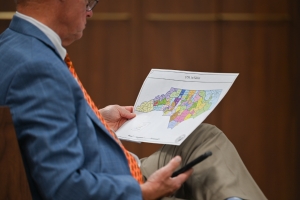 A state lawmaker examines the N.C. Senate proposal of new state Senate districts as the N.C. General Assembly members debate the proposed redistricting maps on Tuesday Nov. 2, 2021.