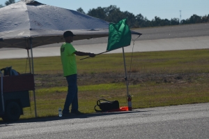 Mike Locklear, of Rockingham, waves the green flag to signal drivers to enter the track at MB Drift&#039;s Halloween Havoc event in October 2021.