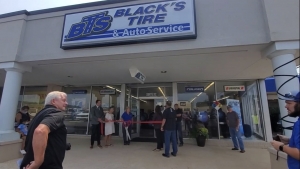 Local dignitaries and company representatives gather for a ribbon-cutting at Black&#039;s Tire and Auto Service in Richmond Plaza.  