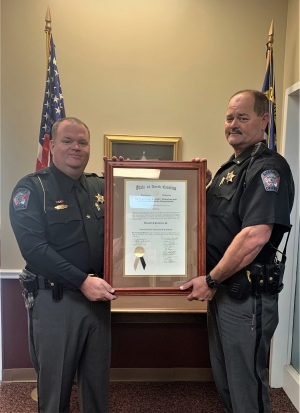 Sheriff Mark Gulledge presents Lt. Clyde Smith with  his Advanced Law Enforcement certificate.