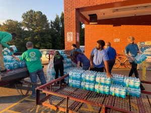 Members of the Marching Raiders and the booster club load up two pallets of water donated by Food Lion.