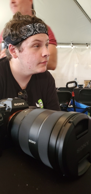 Jordan Lester takes a break from photographing bands at Epicenter Festival in May. The 16-year-old has been freelancing movie and music reviews for the Dunn Daily Record since he was 12.