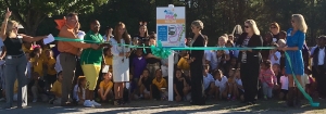 Dr. Kate Smith (center) prepares to cut the ribbon of Mineral Springs Elementary&#039;s new &quot;Daily Mile&quot; trail.