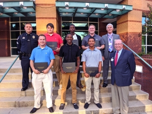 The graduates of Richmond Community College’s Basic Law Enforcement Training program stand with the college president and the BLET training officers. Pictured are, from left, first row, Dylan Scherer, Amante Carswell, Trinity Jernigan and Dr. Dale McInnis; from left, second row, Rockingham Patrol Sergeant Ronnie Brigman, Haiden Evans, Calvin House, John A. Martin Jr. and Rockingham Police Chief Billy Kelly. Not pictured is BLET graduate Makenzie Davis.