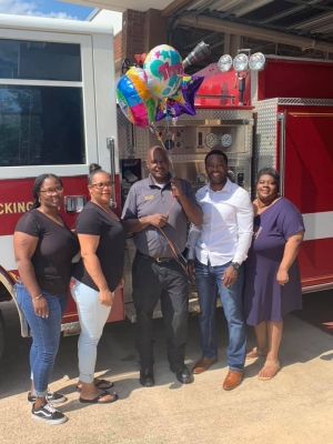 Rockingham Fire Department Assistant Chief Vernon McKinnon is thanked by the Terry family for his life-saving actions in June.