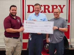 Richmond County Emergency Services Deputy Director T.J. Wilkerson, left, and Derby Volunteer Fire Department’s Capt. Warren McBride, right, accept a $5,000 check from N.C. Insurance Commissioner Mike Causey on Tuesday.