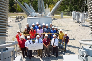  David McNeill, district manager for Duke Energy, (left) holds an oversized check with Dr. Dale McInnis, president of Richmond Community College, representing the $50,000 grant Duke is awarding the Electric Utility Substation and Relay Technology program. Pictured with them are college faculty, staff and EUSRT students.