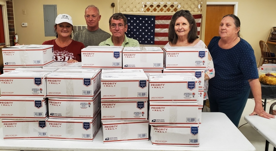 Members of VFW Post 4203 and its Auxiliary stand behind 31 care packages bound for Thule Air Base in Greenland. Pictured, from left: Auxiliary President Robin Roberts; Post Senior Vice Cmdr. Tim Grooms; Post Quartermaster Vernon Labore; Auxiliary Jr. Vice President Kay Jones; and Auxiliary Conductor Clarice Lynn.