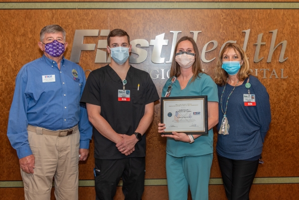 Pictured is Frank Blalock, Employer Support of the Guard and Reserve North Carolina committee member; Gabriel Petersen, R.N., Judi Russell, R.N., Patriot Award recipient; and Angie Stone, MSN, R.N., administrative director, inpatient cardiac services.