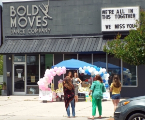 Guests pull up to a drive-by baby shower for Holly Howe and Sarah Phillips of Bold Moves Dance Studio.