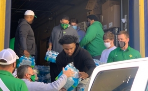Richmond Senior High School student athletes load up water donated by Food Lion.