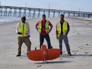 D&#039;Anthony Ravenell (left) stands with two NCDOT employees during an operation on North Carolina&#039;s coastline to monitor coastal erosion with a drone.