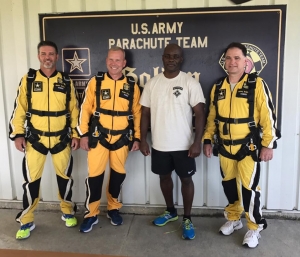 RSHS&#039; athletic director Ricky Young, JROTC directors LTC. Jon Ring and 1SG Aaron Light, and principal Jim Butler pose in front of the U.S. Army&#039;s Golden Knights Parachute Facility.