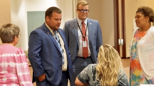Rep. Ben Moss speaks with teachers going through training. Also pictured is Josh McGee, a former teacher cadet from Richmond County, who now works with the Department of Public Instruction.